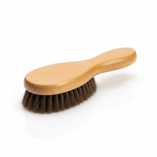 Soft bristle shoe brush with natural wooden handle on white background